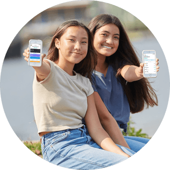 Two girls holding their phones showing the home screen of the Till app