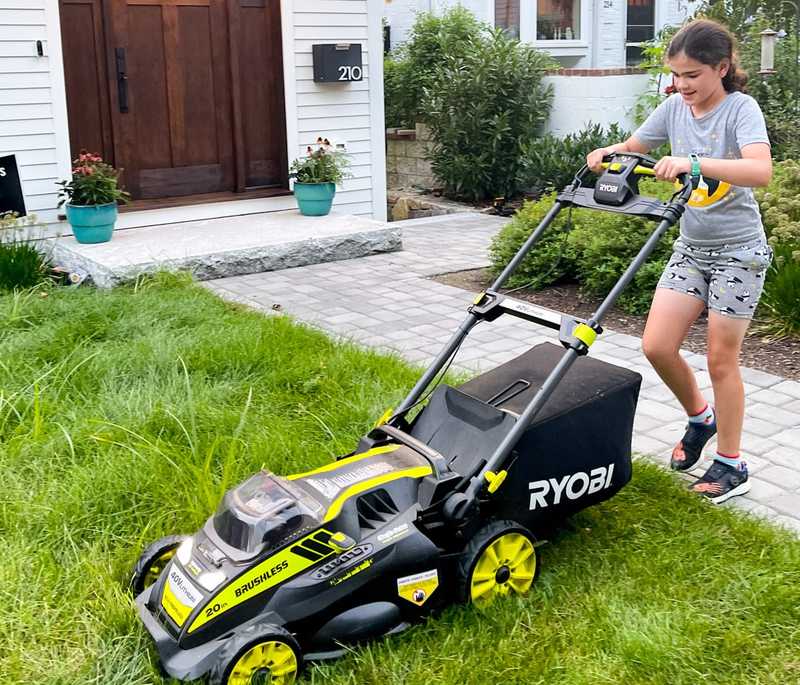 Teenager mowing the lawn to earn an allowance