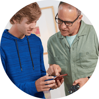 Father showing his son how to use the Till app on his phone