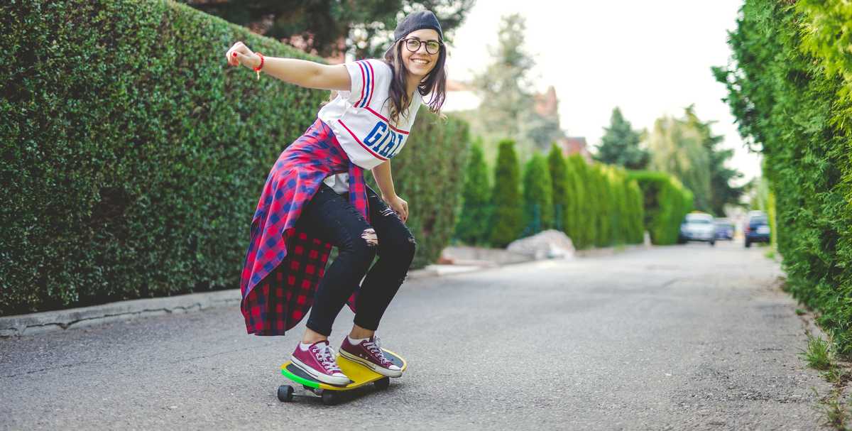 a young lady skateboarding down the street