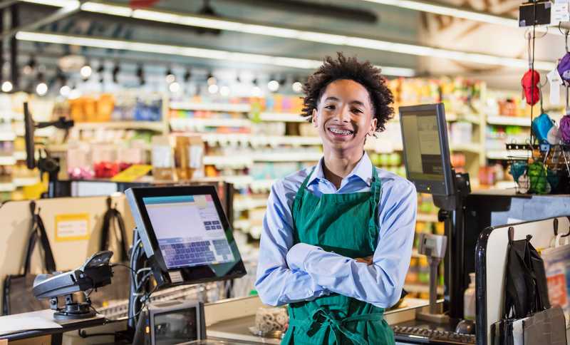 A young boy working at the grocery store